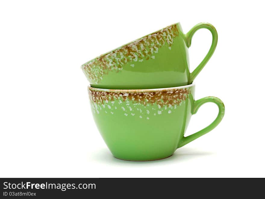 Two cups of green with ornament on white background.