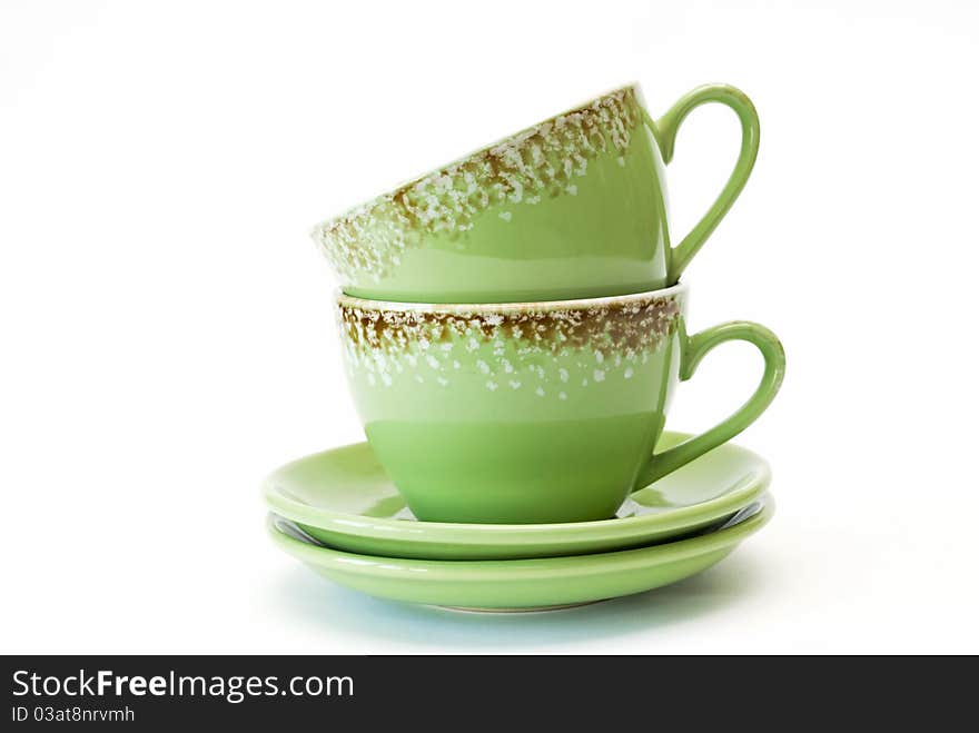 Two cups of green with ornament on white background.