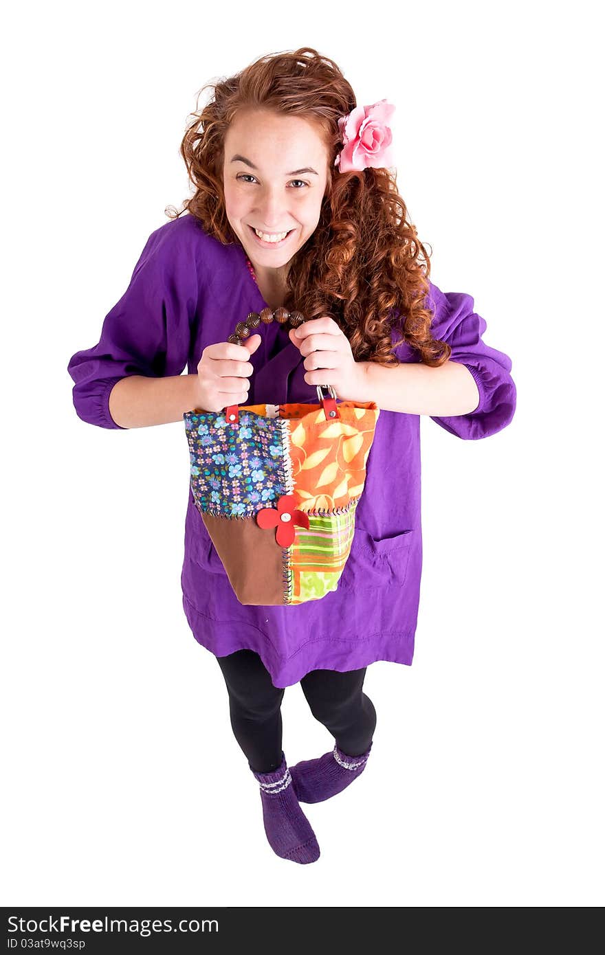 Beautiful teen girl with a little bag on white background