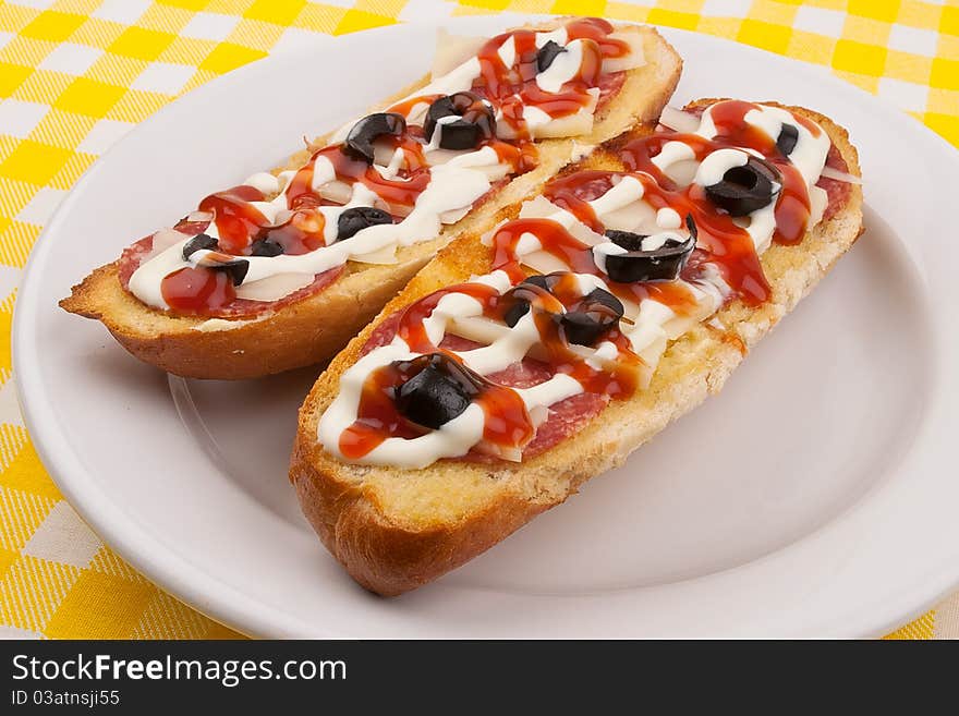 Two salami sandwiches on a plate