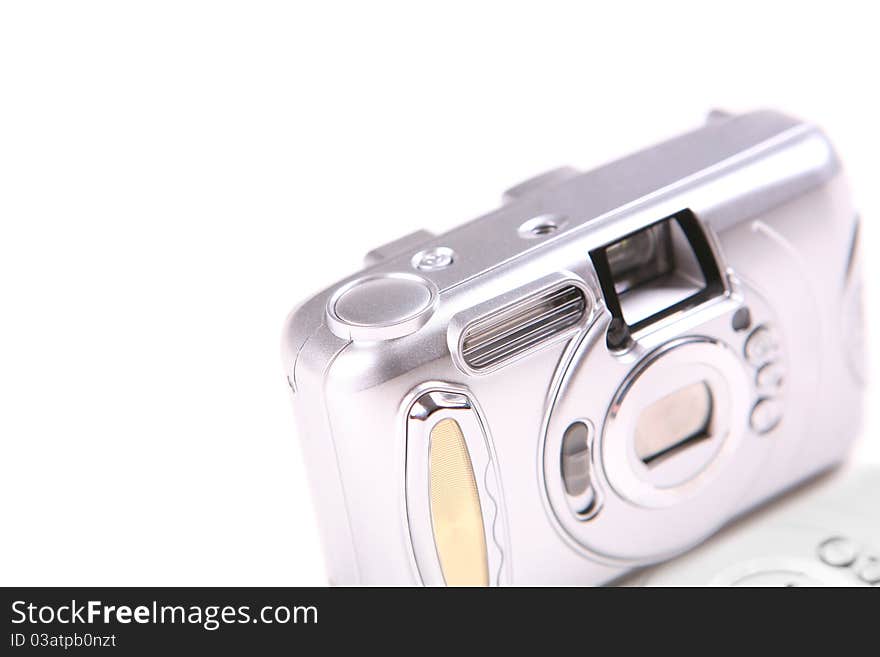 The small silver camera on a white background.