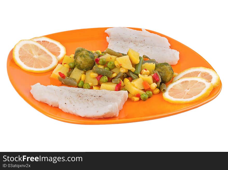 Vegetables and fish on orange plate isolated on white background