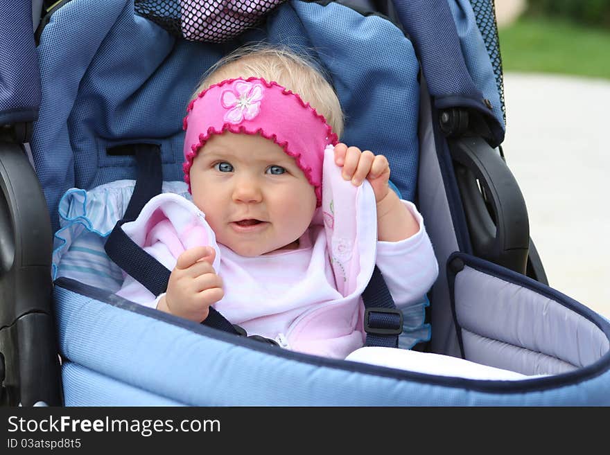 Sweat girl in blue pram. Sweat girl in blue pram