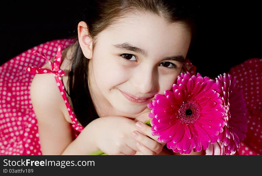 Cute little girl with a pink flower. Cute little girl with a pink flower.