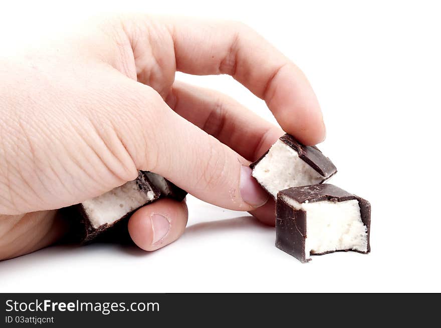 Delicious candy in hand on a white background