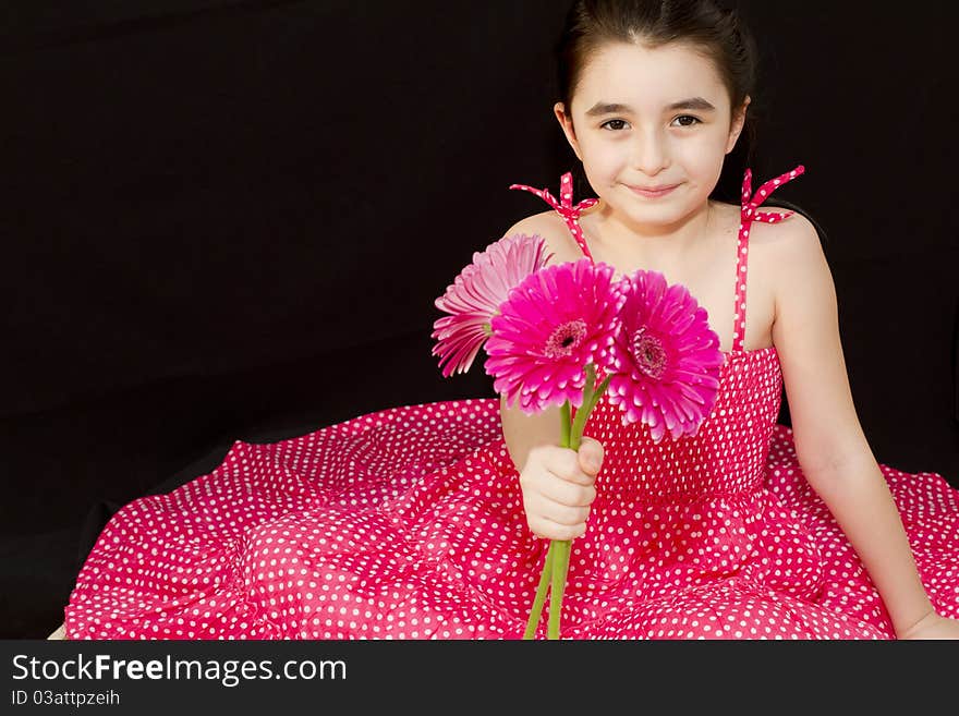 Little girl giving a bouquet of pink flowers to someone. Little girl giving a bouquet of pink flowers to someone.