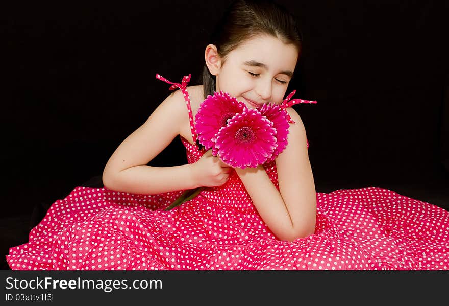 Little girl loving pink flowers. Little girl loving pink flowers