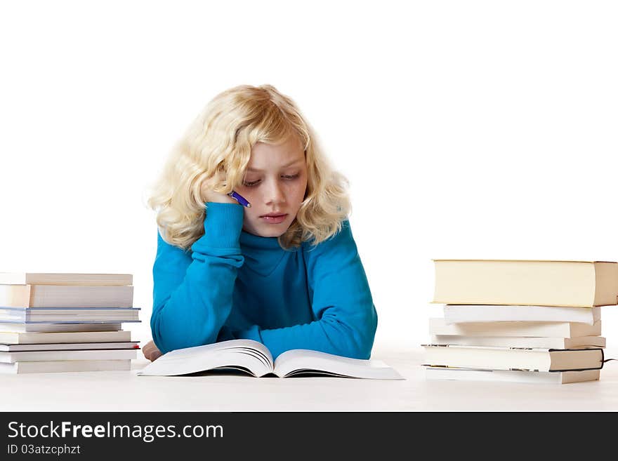 Schoolgirl lying on floor doing homework. Isolated on white background.