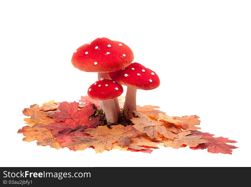 Red dotted decoration mushrooms with leaves isolated on a white background