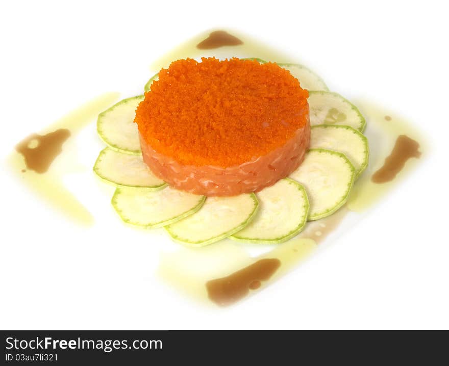 Studio photography of a salmon dish with zucchini and caviar isolated on white