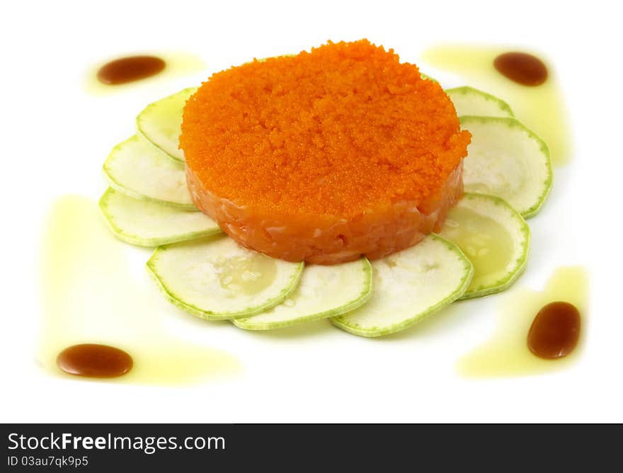 Studio photography of a salmon dish with zucchini and caviar isolated on white