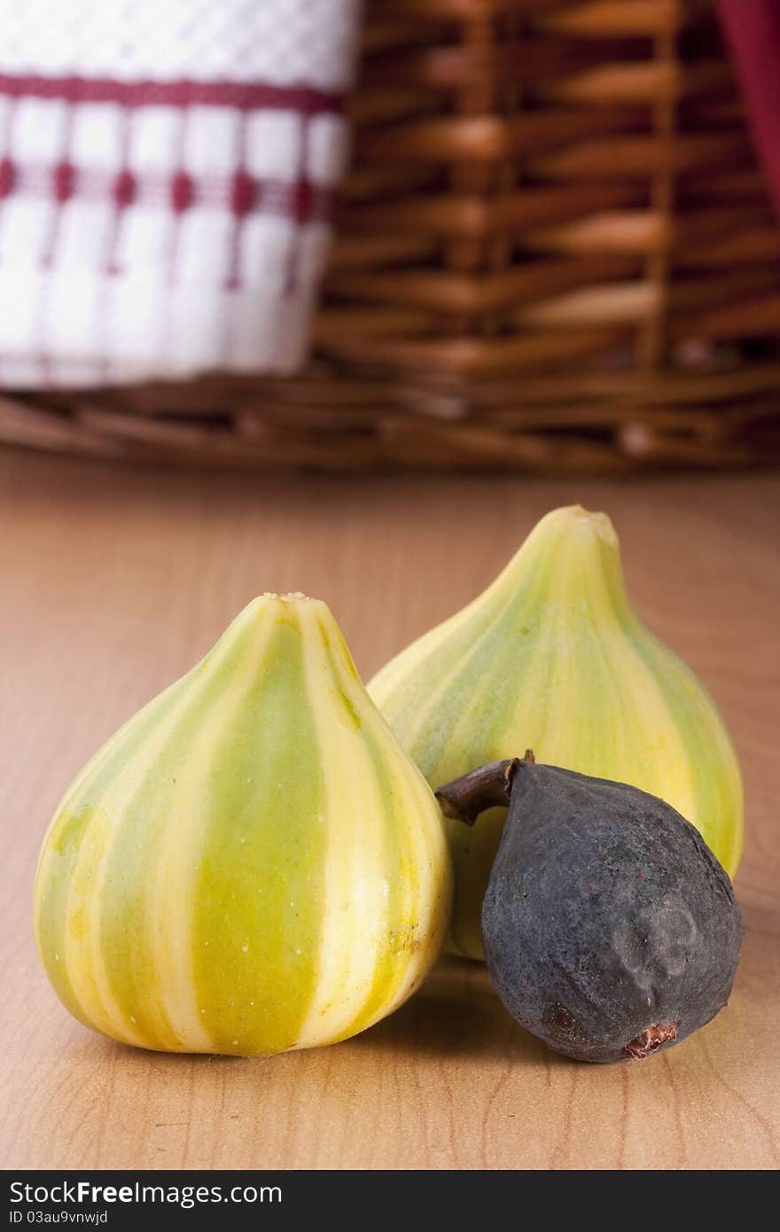 Ripe fruits of a fig on a wooden table.