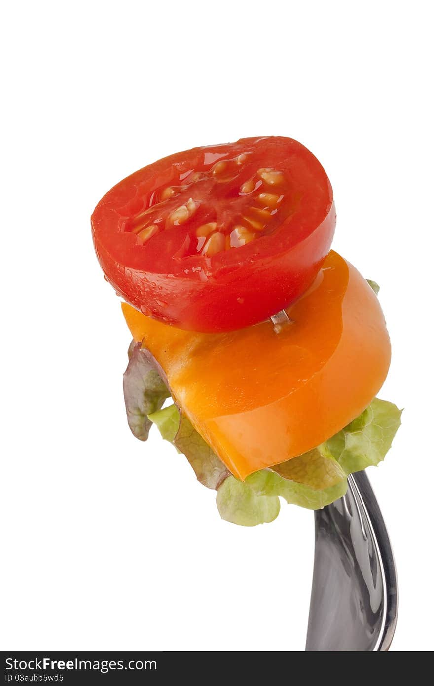 Sandwich of tomato, peppers and lettuce on a fork. Sandwich of tomato, peppers and lettuce on a fork.