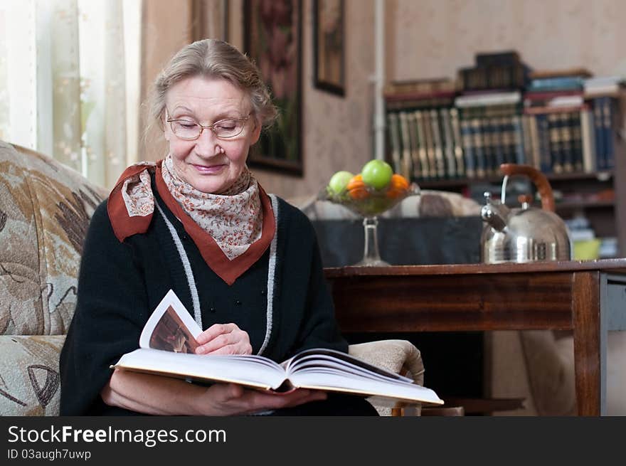 Senior woman reading in her room