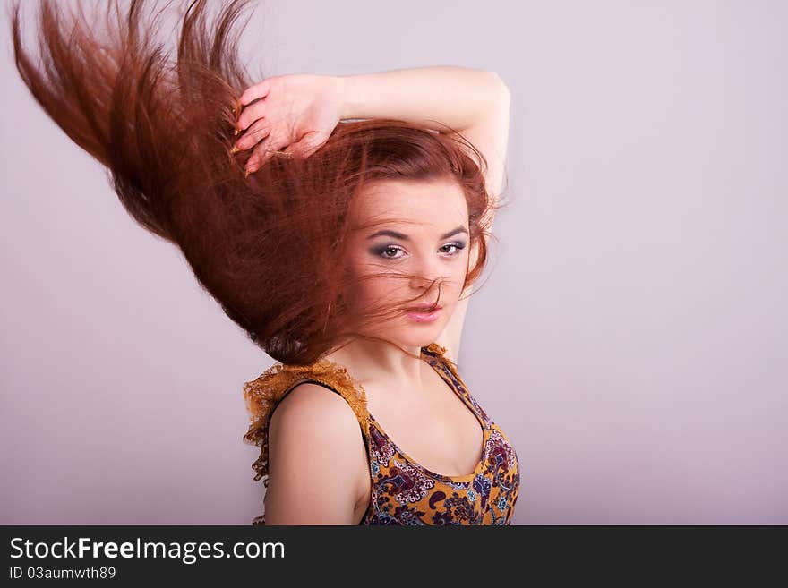 Portrait of a pretty girl with hair fluttering in the wind