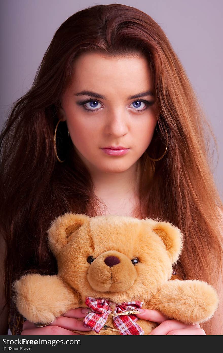 Beautiful longhair girl is holding the teddy bear. Beautiful longhair girl is holding the teddy bear