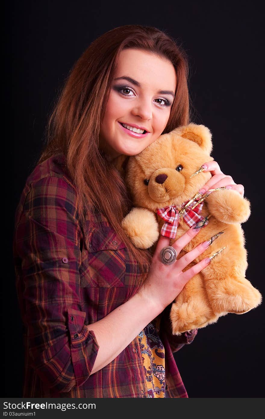 Beautiful longhair girl is holding the teddy bear. Beautiful longhair girl is holding the teddy bear