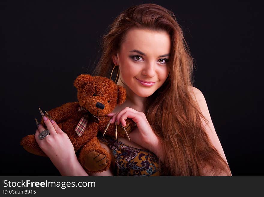 Beautiful longhair girl is holding the teddy bear. Beautiful longhair girl is holding the teddy bear