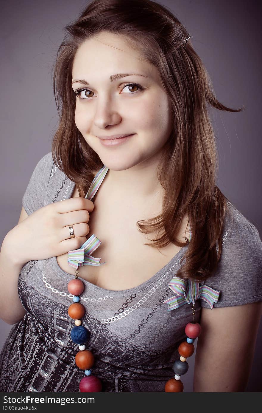 Pretty young girl in colorful beads with ribbons