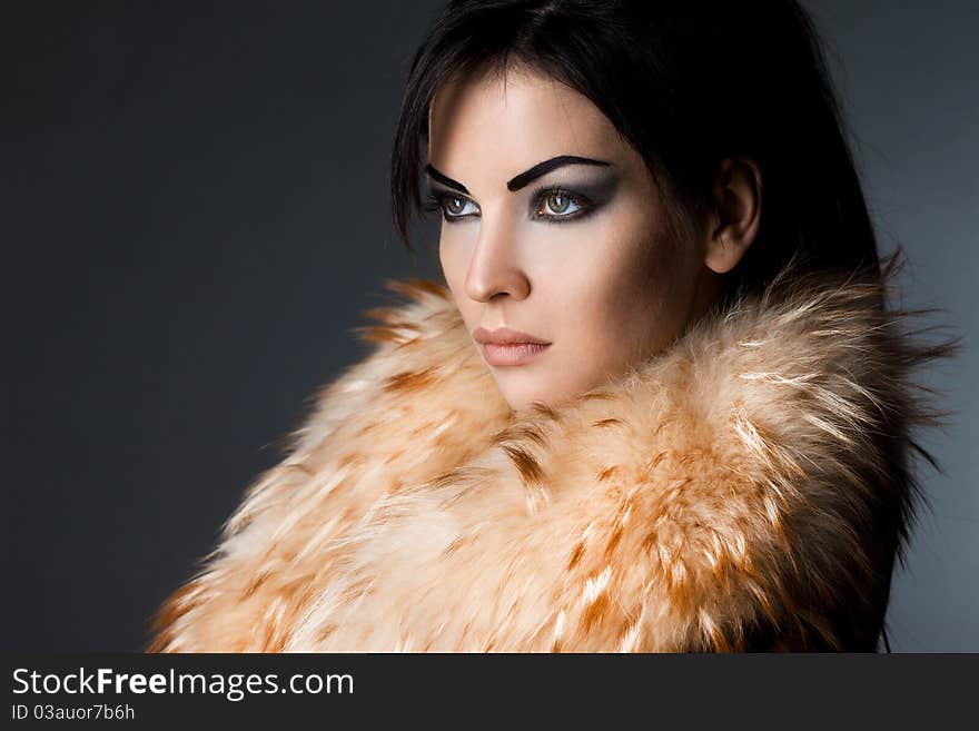 Fashionable woman in fur coat