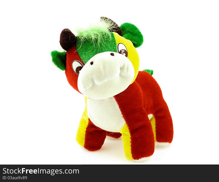 A toy multicoloured cow on a white background