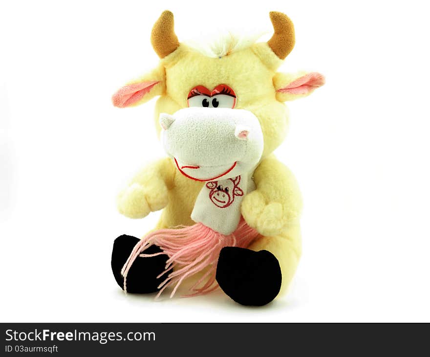 A toy peach cow on a white background