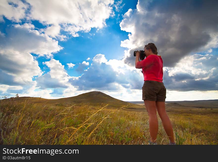 Girl taking picture on natural background. Girl taking picture on natural background