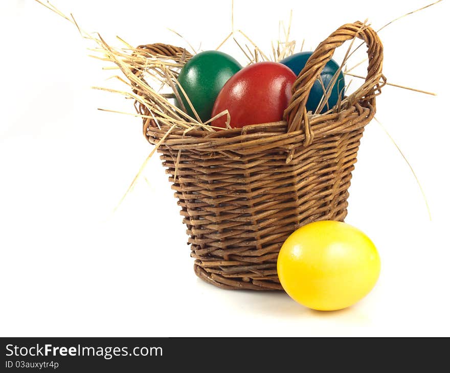 Some easter eggs in a basket isolated on white background