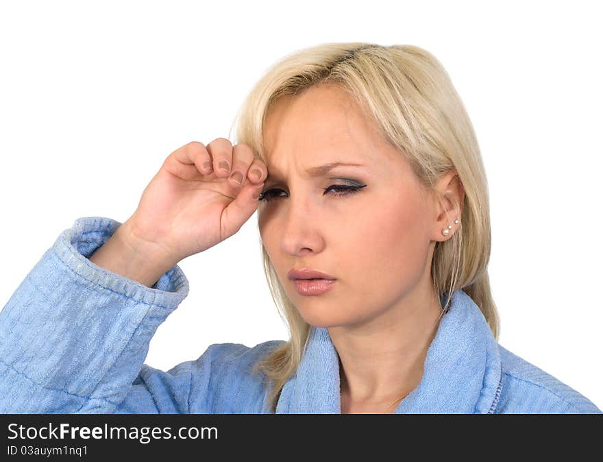 The blonde in a dressing gown with a headache it is isolated on a white background. The blonde in a dressing gown with a headache it is isolated on a white background.