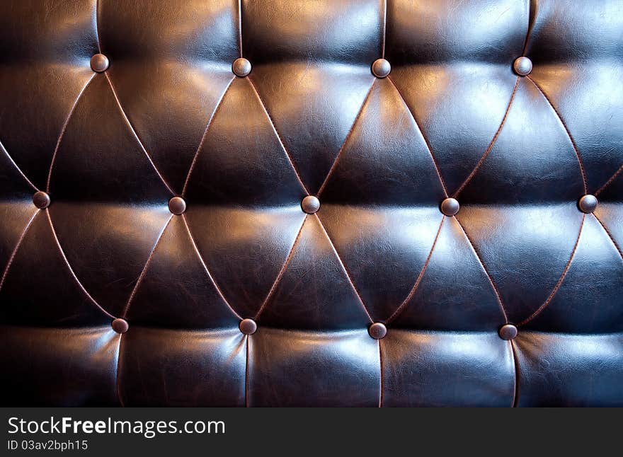 The material of leather armchair with buttons.