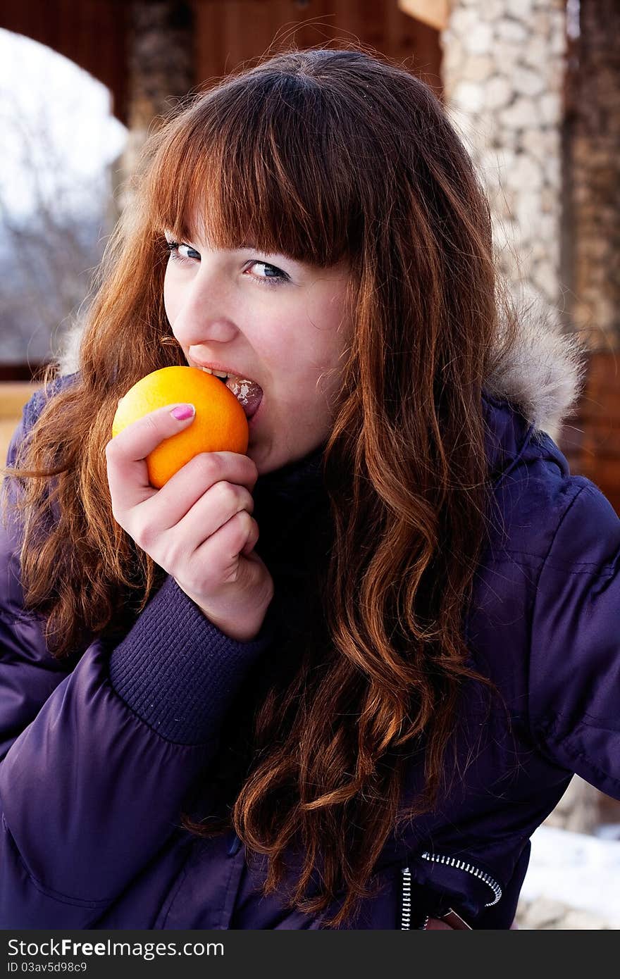 Girl eating orange