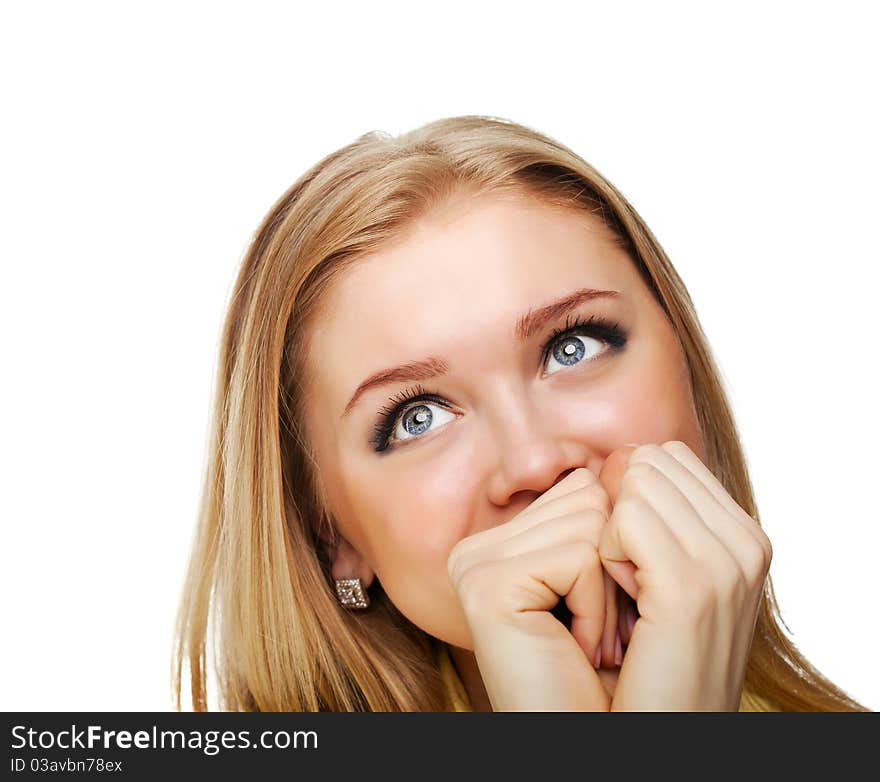 Portrait shot of a beautiful caucasian woman. Holding her face in astonishment.