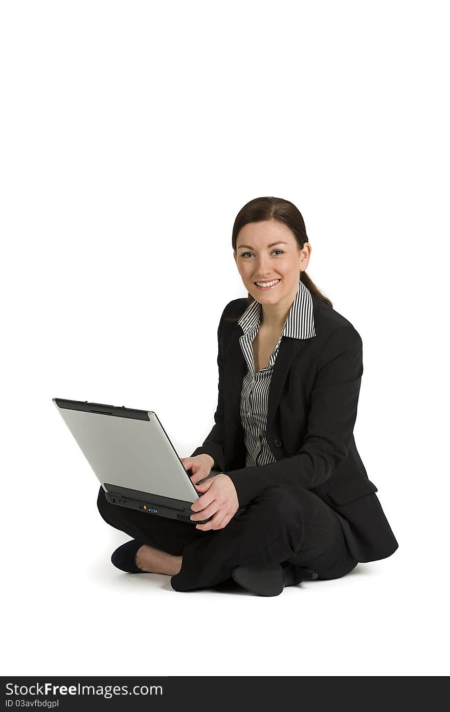 Portrait of a cute business woman sitting with a laptop isolated against white. Portrait of a cute business woman sitting with a laptop isolated against white