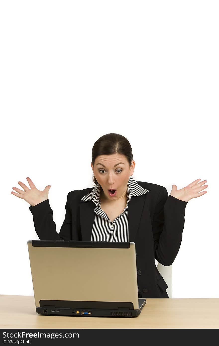 Portrait of a beautiful young businesswoman, acting suprised while looking at her laptop, on white. Portrait of a beautiful young businesswoman, acting suprised while looking at her laptop, on white.