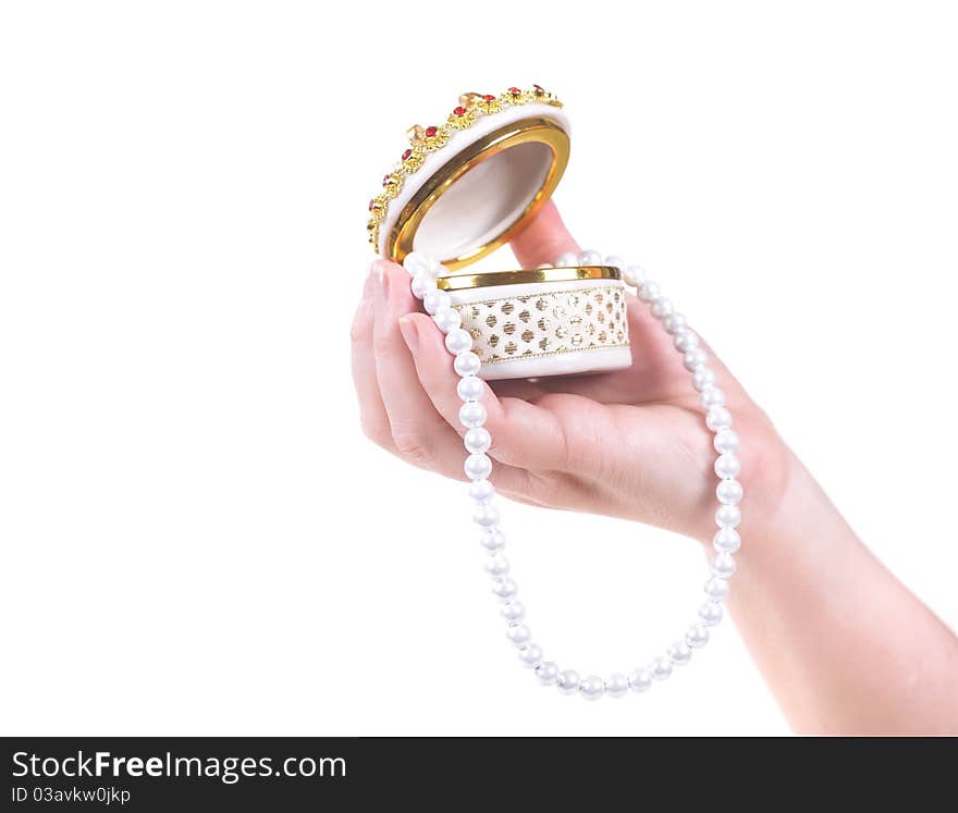 Pearl necklace and casket on a female palm.