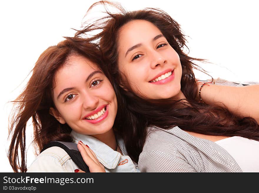 Two women smiling at the camera over white background