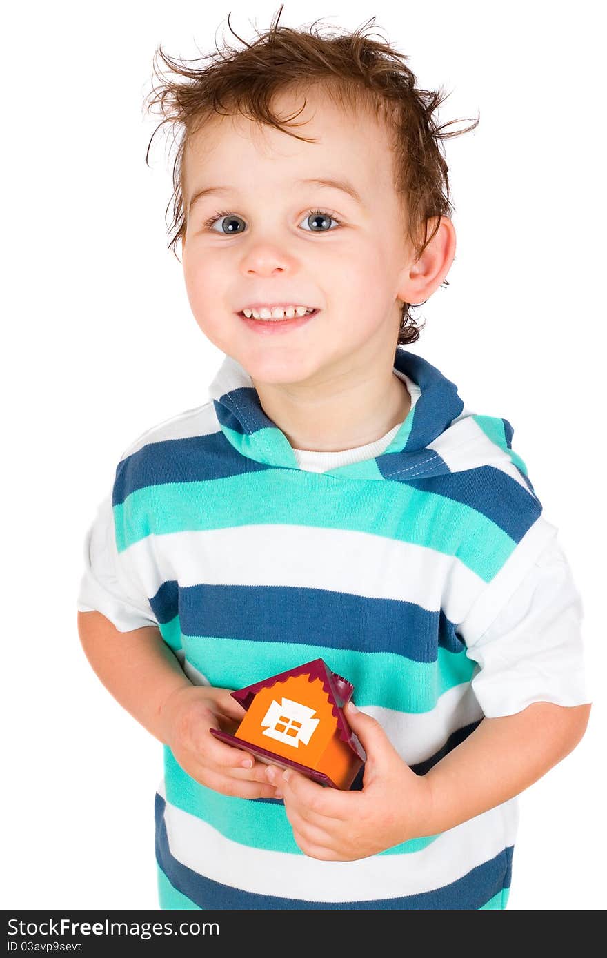 Smiling boy holding a toy house isolated on white