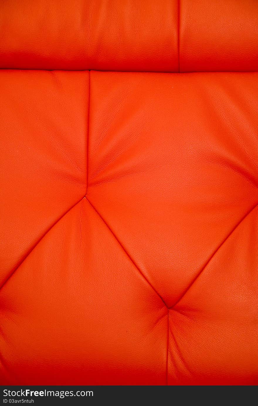 Stitchings on background of vertical red leather couch. Stitchings on background of vertical red leather couch