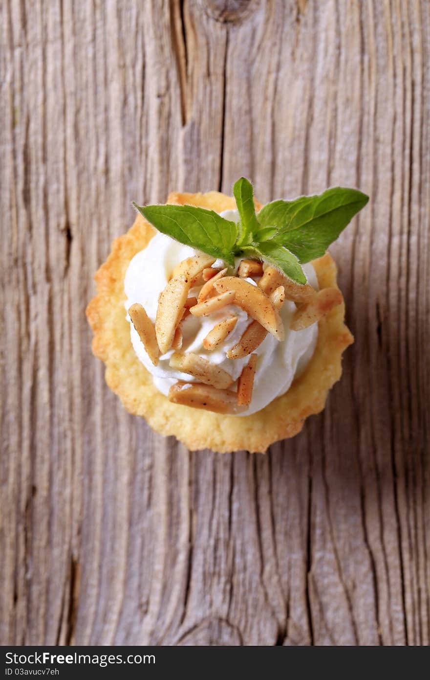 Tartlet pastry with cheese spread and roasted almonds. Tartlet pastry with cheese spread and roasted almonds