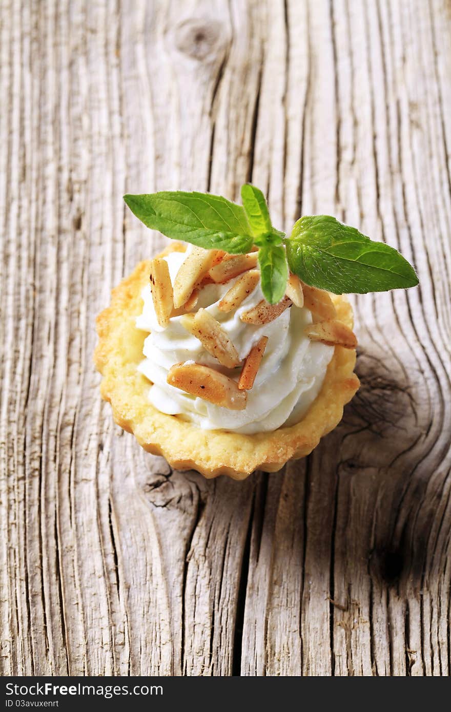 Tartlet pastry with cheese spread and roasted almonds. Tartlet pastry with cheese spread and roasted almonds