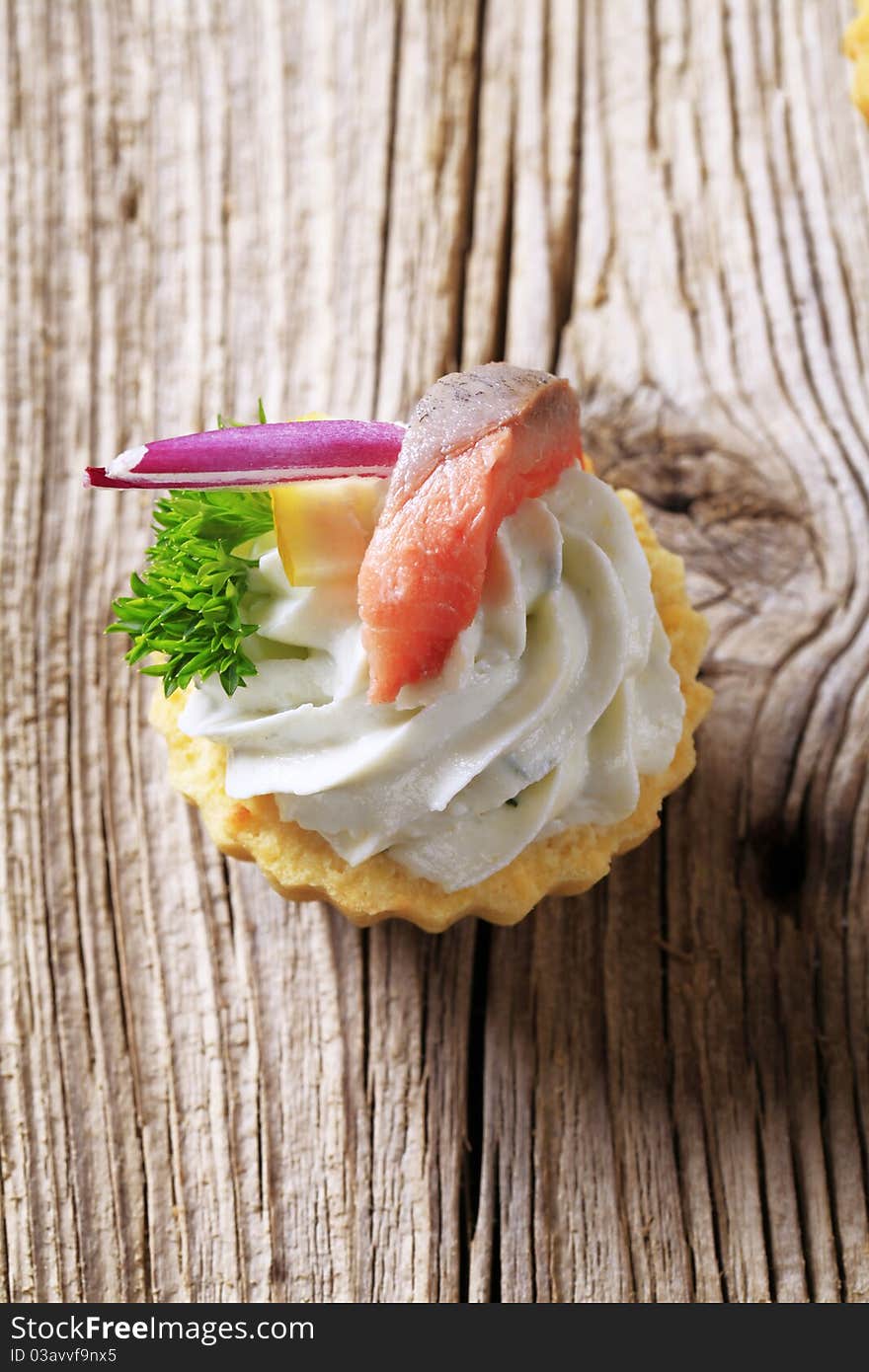 Tart pastry shell with cheese spread and fish. Tart pastry shell with cheese spread and fish