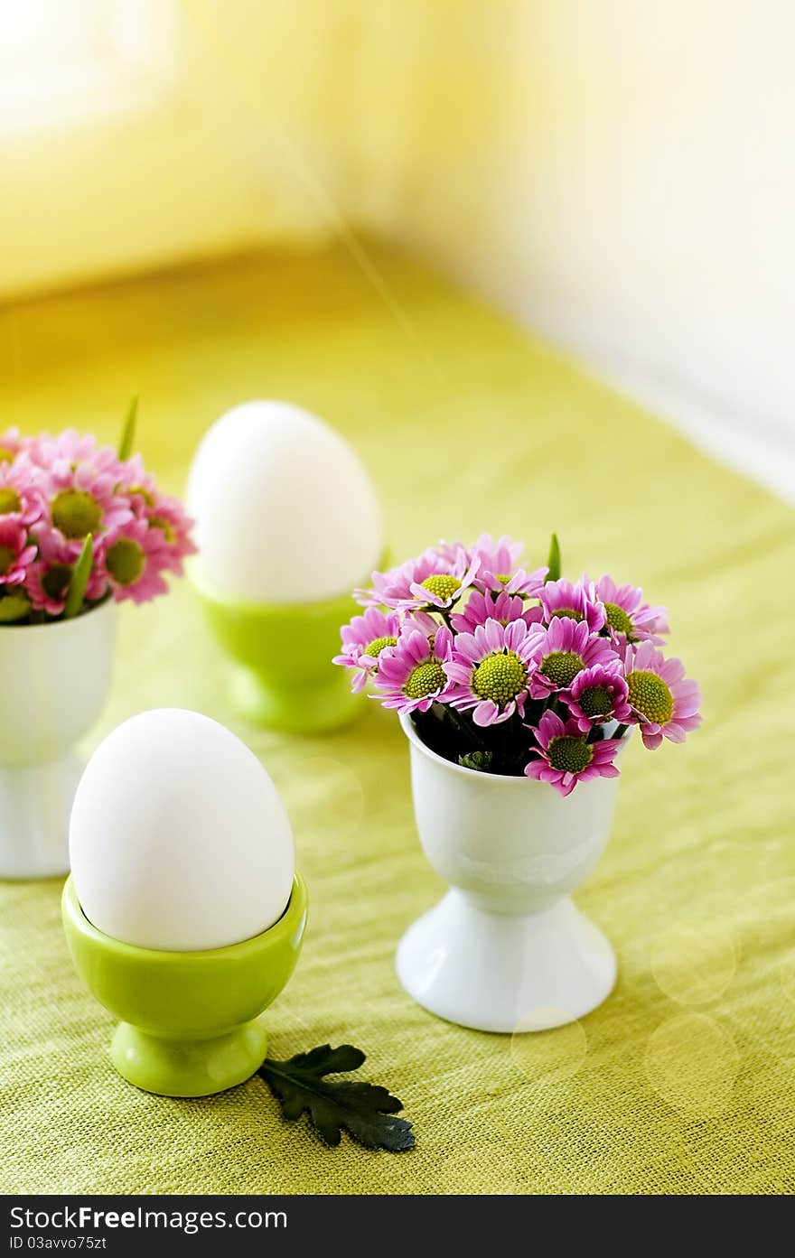 Easter eggs and flowers in an egg cups