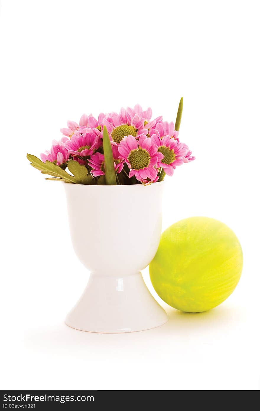 Easter egg and pink flowers isolated on white background