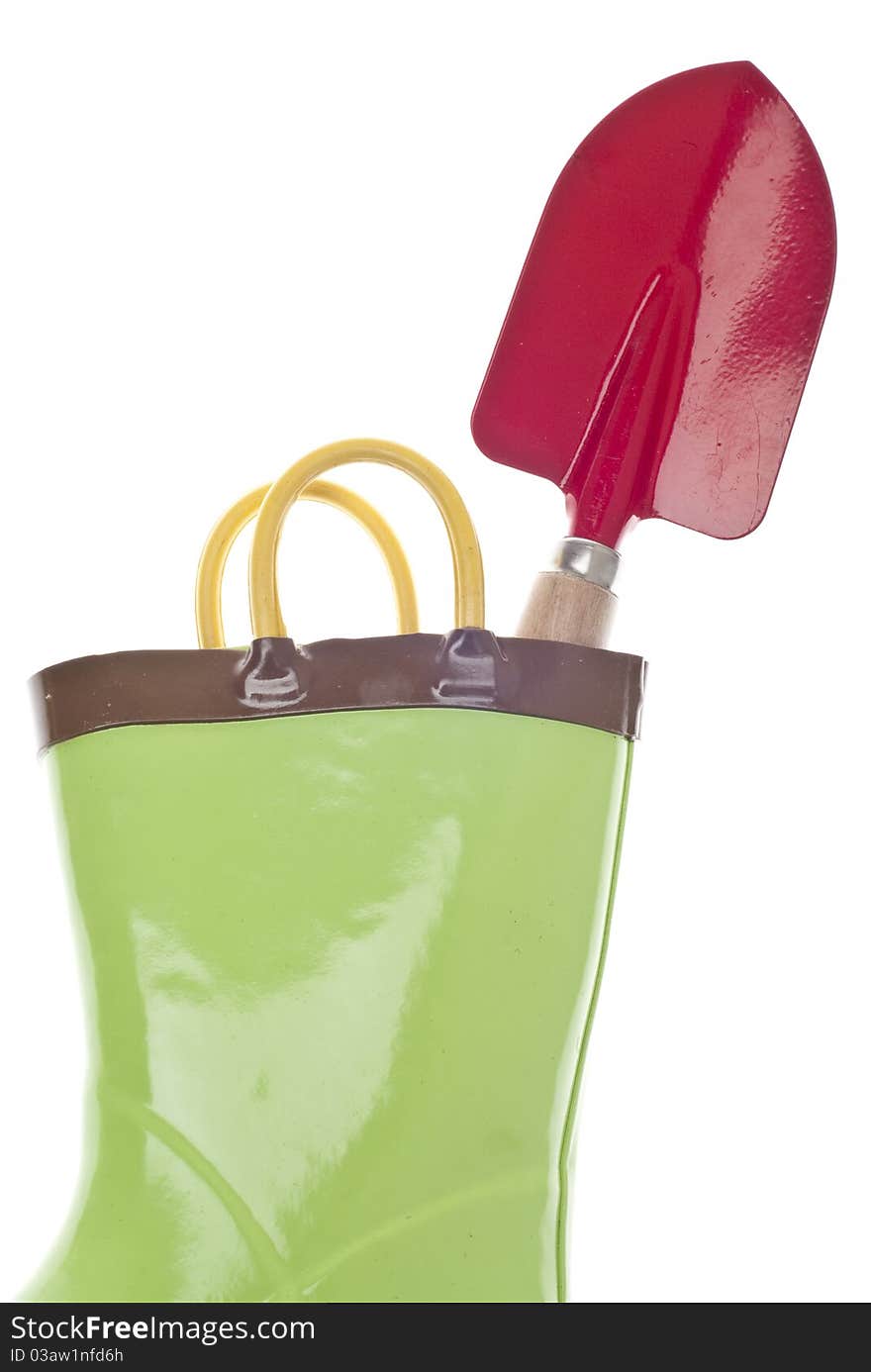 Green Gardening Boots with a Red Garden Shovel Spade.