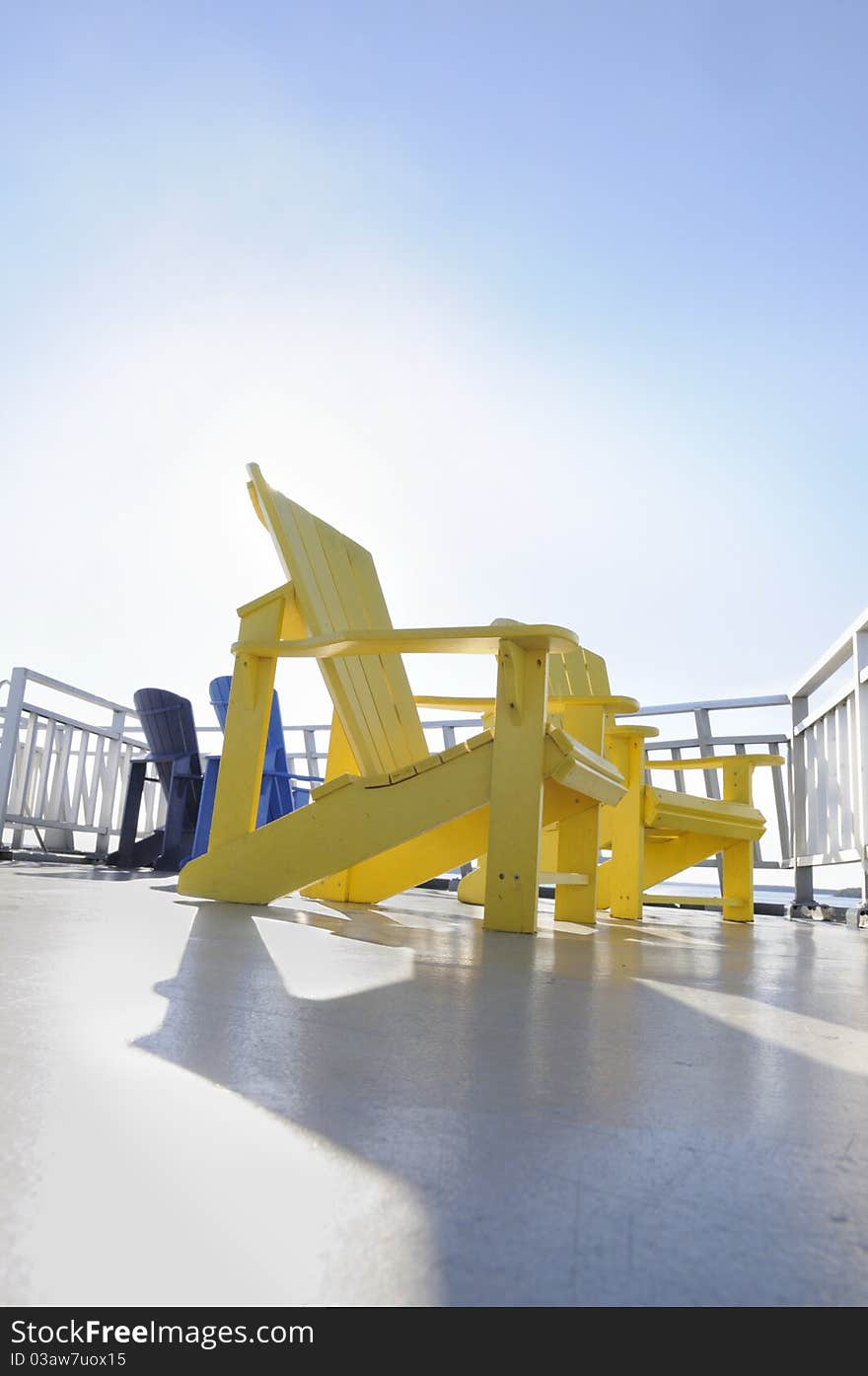 A yellow chair on a cruise deck. A yellow chair on a cruise deck.