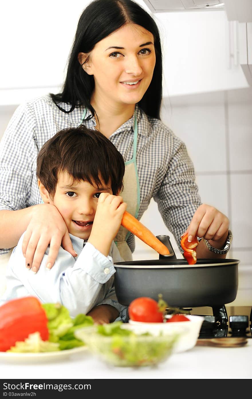 Happy mother and little son in the kitchen, happy time and togetherness