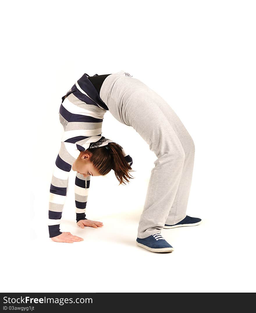 Beautiful young woman makes stretching isolated over white background