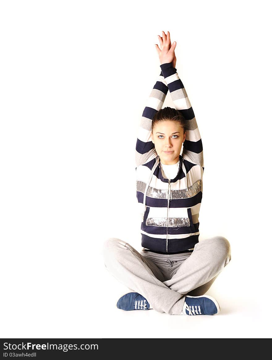 Beautiful young woman makes stretching isolated over white background