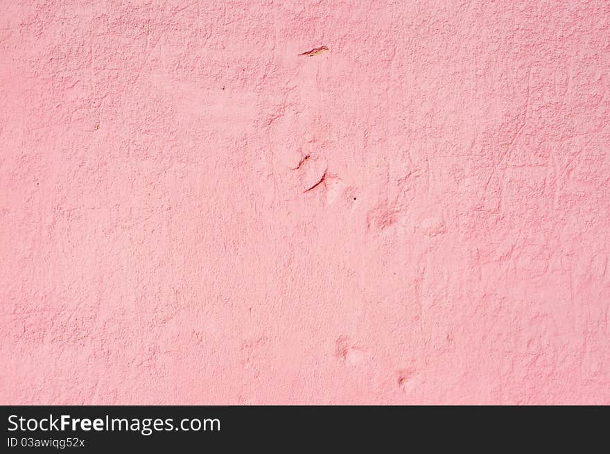 A view of a painted wall of cememt blocks in the color of red. A view of a painted wall of cememt blocks in the color of red.