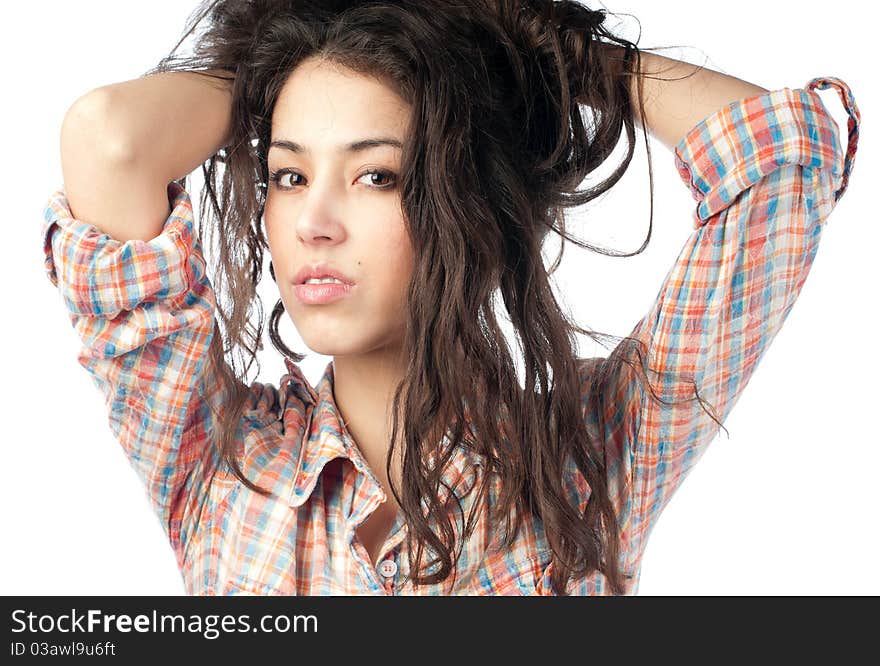 Beautiful and glamourous young woman with dark wavy hair, hands in hair, looking into the camera. Isolated on white background. Beautiful and glamourous young woman with dark wavy hair, hands in hair, looking into the camera. Isolated on white background.